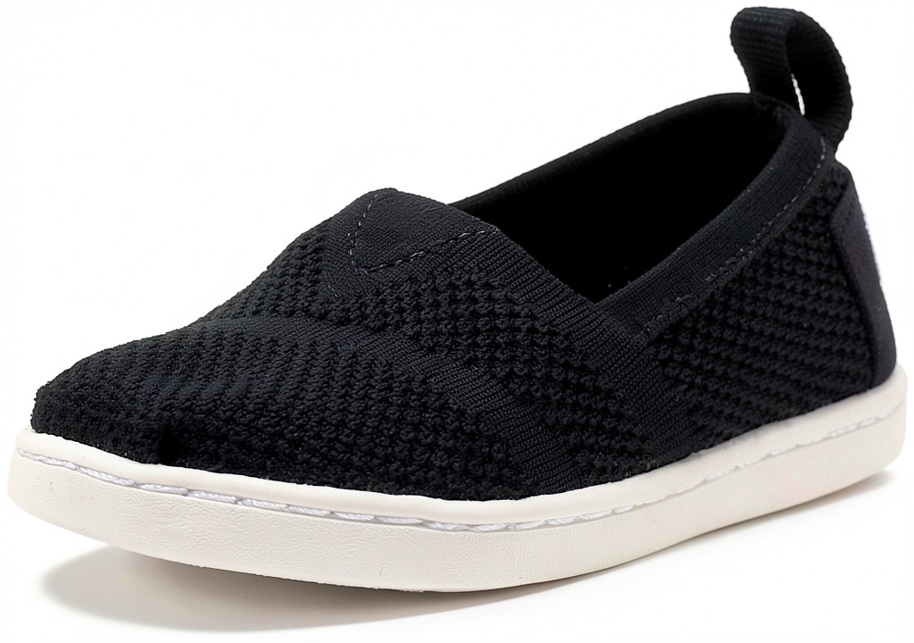 TOMS Mesh Shoe Black Classic Cycling Toddler Girls Mens being worn while cycling in urban setting